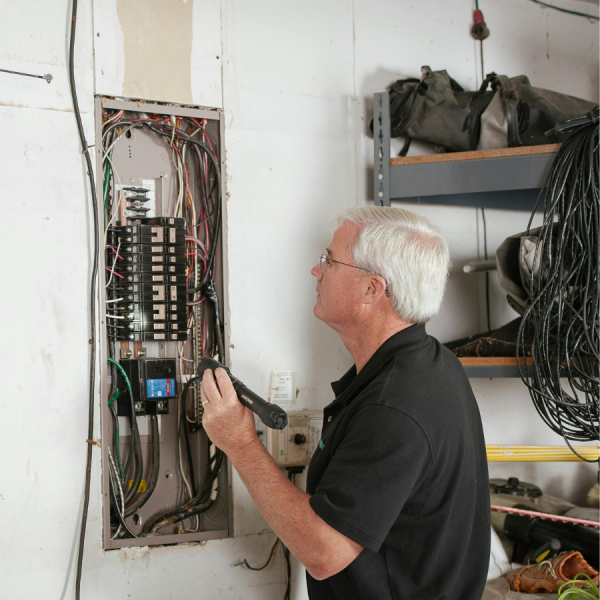 An electrician before a breaker box.